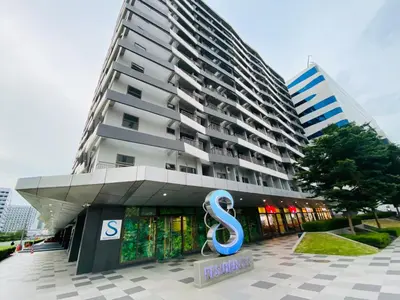 a large building with a sign in front of it at Condotel at S Residences near SM MOA, SMX, Arena, NAIA Airport in Manila