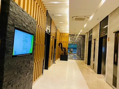 a hallway in a building with a tv on a wall at Condotel at S Residences near SM MOA, SMX, Arena, NAIA Airport in Manila