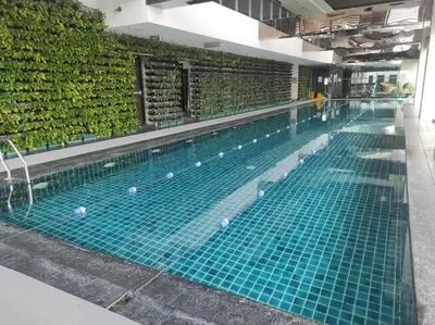 a swimming pool with balls on the water at Cozy Apartment City & Mountain View with balcony FREE use of pools sauna and sunbathing in Manila