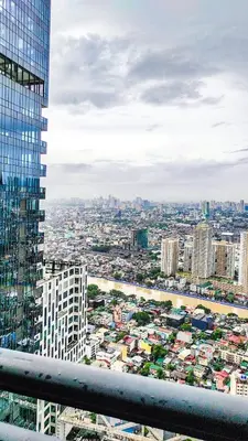a view of a city from a building at Cozy Apartment City & Mountain View with balcony FREE use of pools sauna and sunbathing in Manila