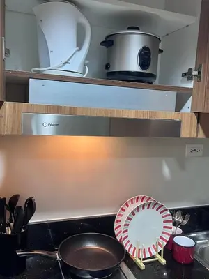 a kitchen counter with a frying pan and a plate on a stove at Unistay SHORE 3 Pool view w Balcony near MOA in Manila