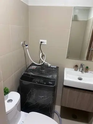 a bathroom with a toilet and a black box at Unistay SHORE 3 Tower 2 10th Floor w Balcony Pool View in Manila