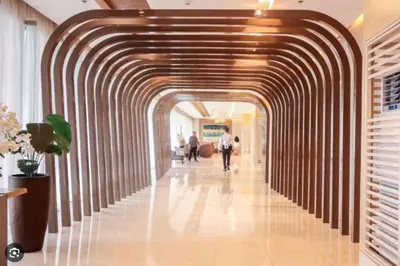 a hallway in a building with a wooden archway at Unistay SHORE 3 Tower 2 10th Floor w Balcony Pool View in Manila