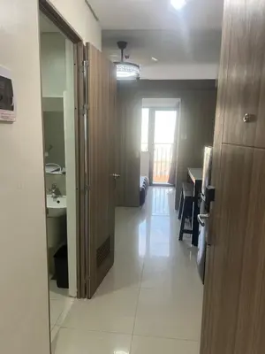 a room with a hallway with a sink and a door at Shore 2 Residences Executive Suite by JMS in Manila