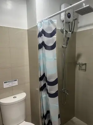a bathroom with a shower with a toilet at Shore 2 Residences Executive Suite by JMS in Manila