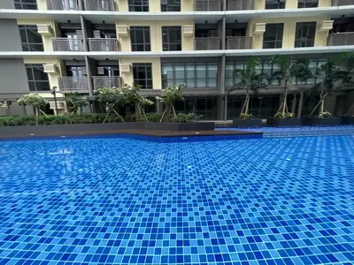 a large blue swimming pool in front of a building at 1BR Executive Suite Beside Okada & Solaire - 4pax in Manila