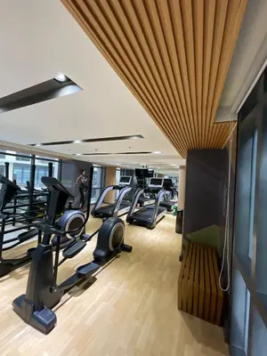a gym with treadmills and elliptical machines at Spacious 1BR near Airport across Okada, Solaire in Manila