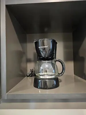 a glass trophy sitting on a shelf at The Residences at BCCT by Stays PH Cozy retreat with hotel-style comforts and convenience, best location in BGC in Manila
