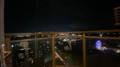 a view of a city at night from a window at The Radiance Manila in Manila