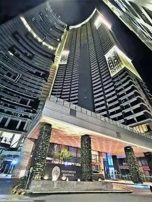a tall building with plants in front of it at David Gelber in Manila