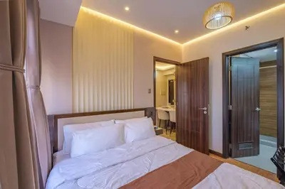 a bedroom with a bed and a bathroom at EC Suites Modern 1Br Suite w Balcony in Pasay in Manila