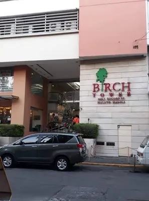 a car parked in front of a building at Modern Studio Birch Tower Near Malls & Nightlife in Manila