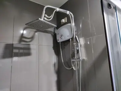 a shower in a bathroom with a shower head at Newly Designed 1BR Top of Makati in Manila