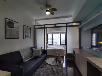 a living room with a couch and a table at Newly Designed 1BR Top of Makati in Manila