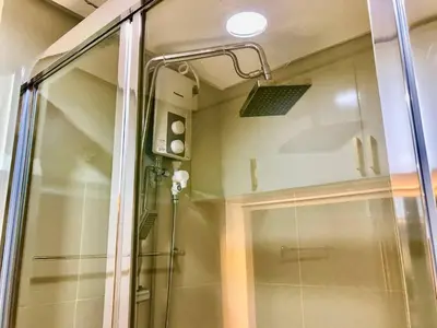a shower in a bathroom with a glass door at CityHomeStay in Manila