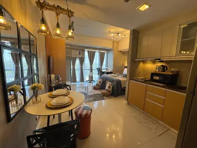 a kitchen and living room with a table and a room at Industrial Chic Studio in McKinley Hill Walk to Venice Mall in Manila