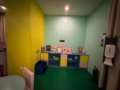 a room with a toy shop with yellow and green walls at Cozy Viceroy 1BR, Walk to Venice Mall in Manila