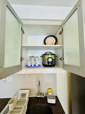 a kitchen with a sink and a toaster at Cozy Viceroy 1BR, Walk to Venice Mall in Manila