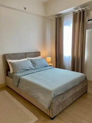 a bedroom with a large bed with a window at Condo unit near SM City Sta Rosa unit 3 in Santa Rosa