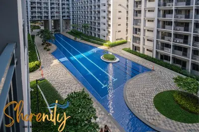 a swimming pool in the middle of some buildings at Shorenity MOA Staycation in Manila
