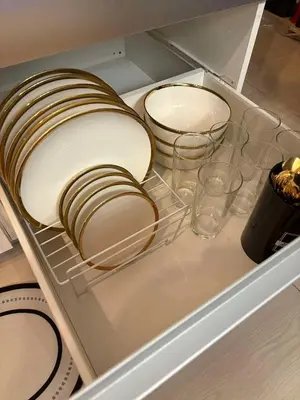 a drawer with plates and glasses in a refrigerator at Celestial Sphere Staycation in Manila