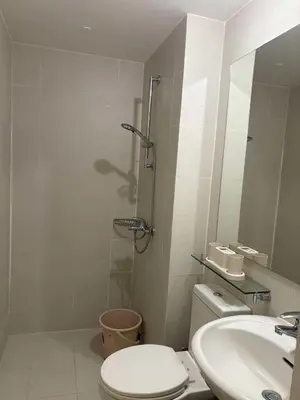 a bathroom with a toilet and a sink and a shower at Celestial Sphere Staycation in Manila