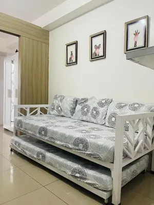a living room with a couch in a room at Shore 1 Condo near MOA - PLS send valid IDs of all guests after booking for guest authorization form purposes in Manila