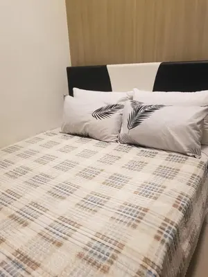 a bed with two pillows on top of it at Shore 2 Residences MOA Pasay Naia in Manila