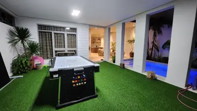 a living room with a barbecue grill on the grass at Nazville vacation home in Pasig