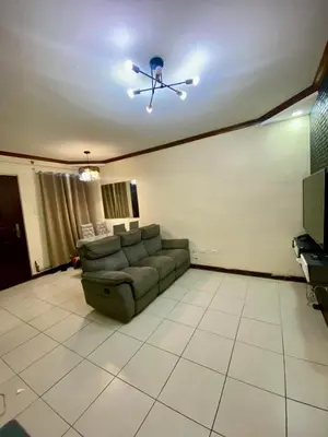 a living room with a couch and a ceiling fan at Dym cozy condo pad in Manila