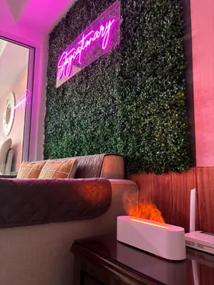 a living room with a couch and a green wall at Azure Urban Resort Residences - Staycationary Miami 1710 in Manila