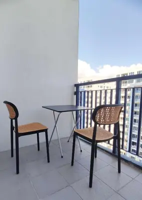 a table and two chairs on a balcony at Suite Escapade in Manila
