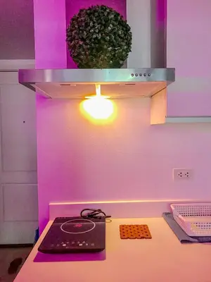 a kitchen with purple lighting and a counter with a stove at Azure Urban Resort Residences by Staycationary 17th floor Miami in Manila