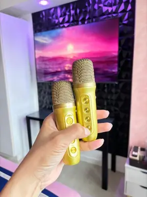 a person holding two microphones in front of a television at Azure Urban Resort Residences by Staycationary 17th floor Miami in Manila