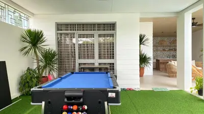 a pool table in the yard of a house at Nazville Vacation Home in Cainta