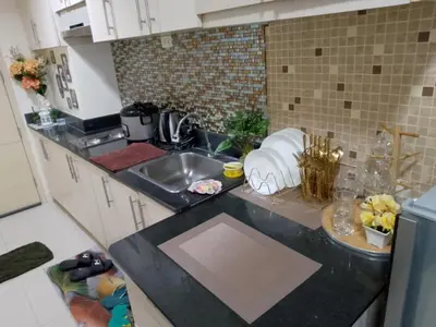 a kitchen with a sink and a counter top at Arcilla stay cation in Manila