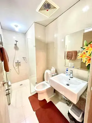 a bathroom with a sink and a toilet and a shower at Airport NAIA T3 Condotel in Manila