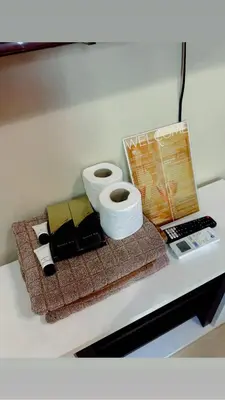a table with two rolls of toilet paper and a laptop at Airport NAIA T3 Condotel in Manila