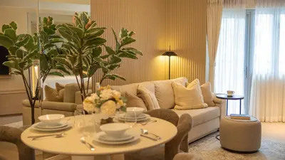 a living room with a couch and a table at Cozy Flat at Makati s Coolest St in Manila
