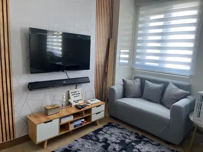 a living room with a couch and a flat screen tv at Aras Solace Place in Trece Martires
