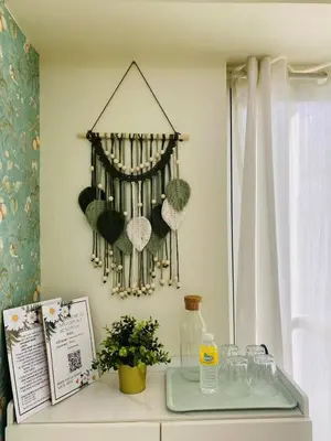 a room with a table with a shelf with hats on the wall at timoncondotel city view in Manila