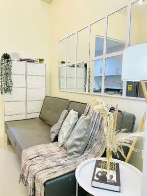 a living room with a couch and a table at SMDC Shore Residences in Manila