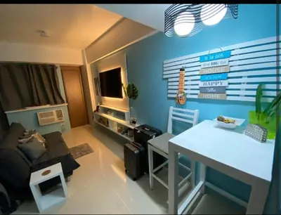 a living room with a couch and a table at One Palm Tree Villas Near NAIA 3 in Manila