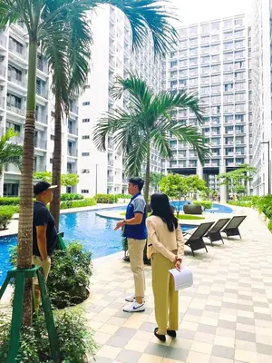 a group of people standing next to a pool at Bella Notte Staycation - SMDC Shore 2 MOA Complex in Manila