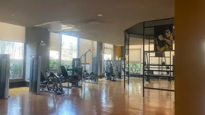 a gym with several treadmills and a large mirror at The Radiance Manila Bay by Mary in Manila