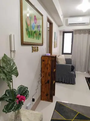 a living room with a bed and a table at The Chill Spot Residences Property Management in Manila