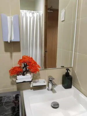 a bathroom with a sink and a mirror at The Chill Spot Residences Property Management in Manila