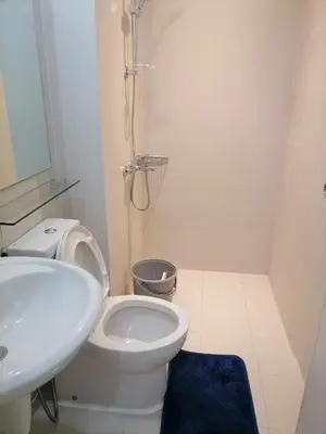 a bathroom with a white toilet and a sink at Premium 1Bedroom Condo Unit Near Airport, MOA, Casinos, SM Bicutan in Manila