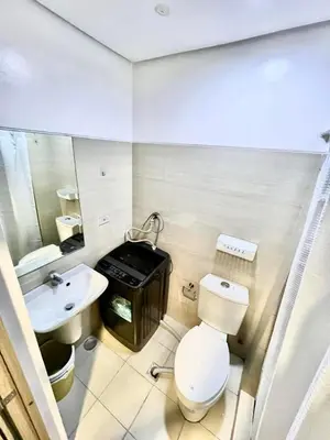 a bathroom with a toilet and a sink at My Serenity Suite in Manila