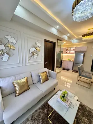 a living room with a couch and a table at Manila Bay Suite in Manila